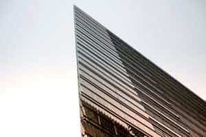 low-angle photography of curtain building under white sky during daytime